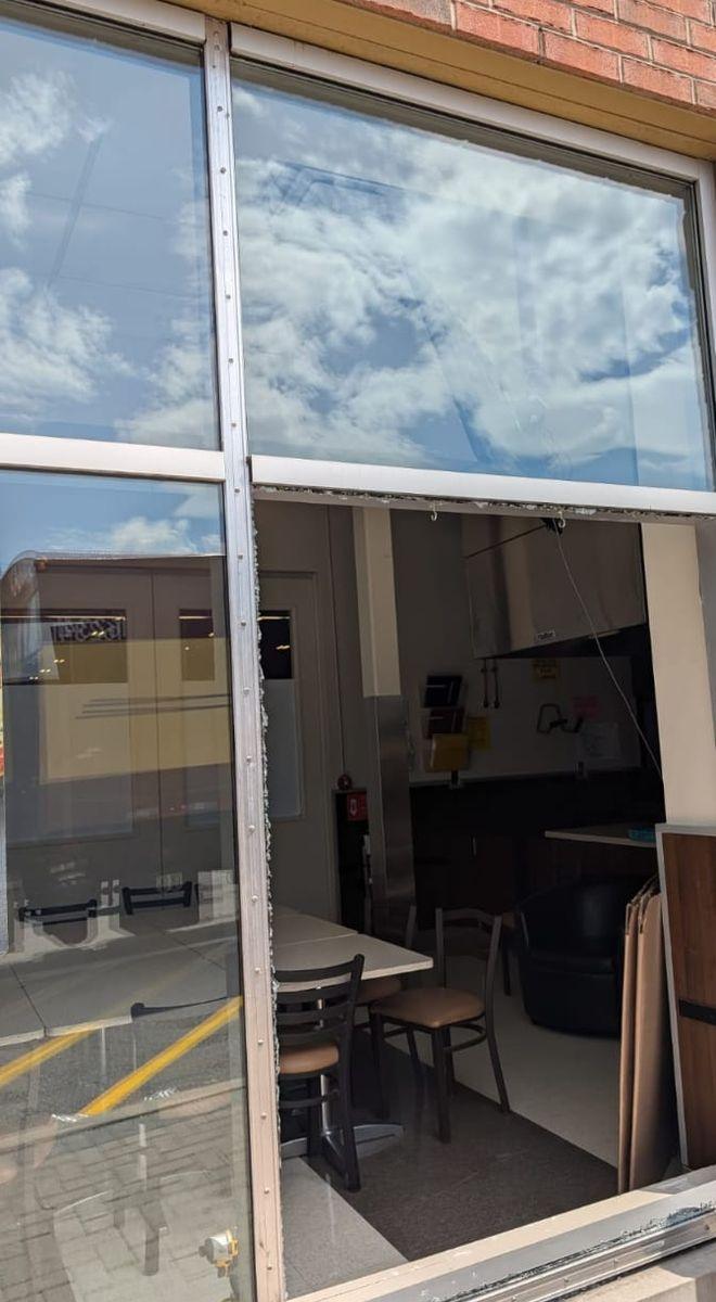 Before: aluminum storefront with the lower glass panel missing, the restaurant interior open to the street